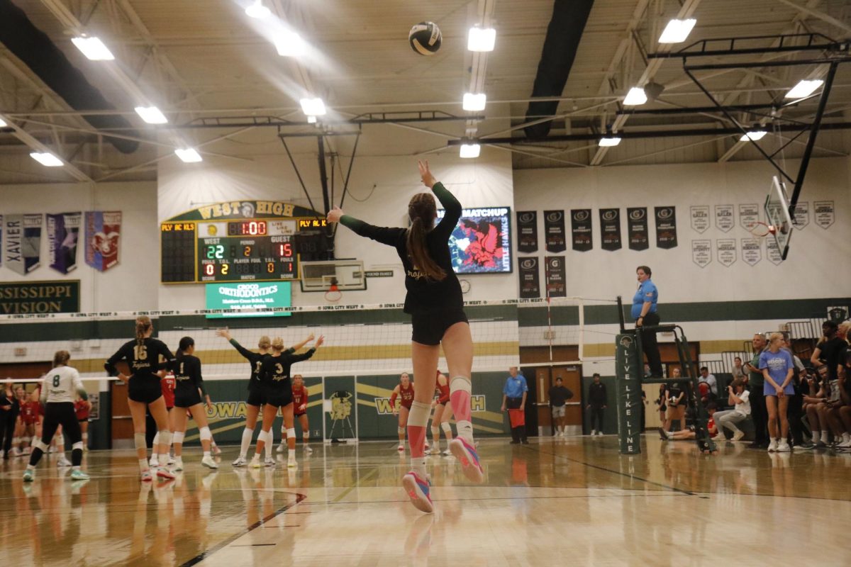 Lila Eastvold ’27 rises up to serve the ball at the beginning of the fourth set against City High. 