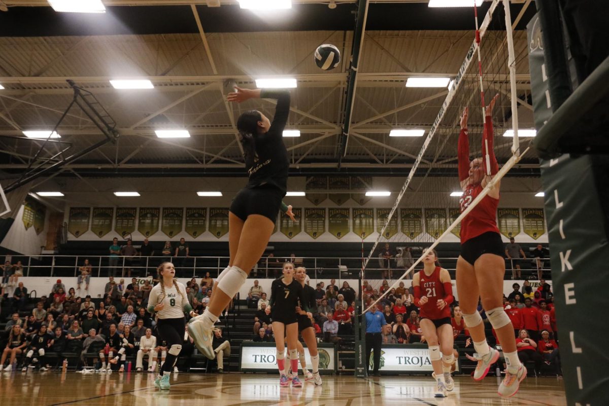 Gracie Liu ’27 leaps up to Spike the ball down into City High territory for the set point. 