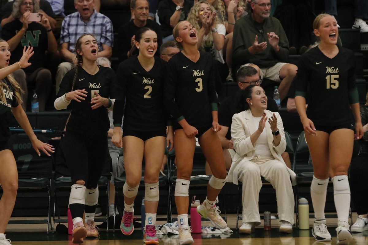 No. 2 Ellie Barnett ’25 and No. 3 Ava Bruxvoort ’25 erupt into a standing ovation after West scores a point. 