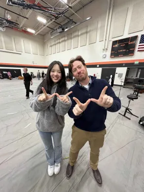 Jessie Li '25 and West orchestra director Jon Welch pose after results were posted Oct. 26.