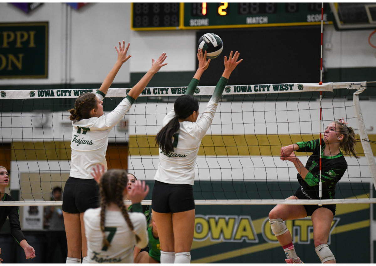 Audrey Small '28 and Gracie Liu '27 put up a block against the Cougars Oct. 2. 