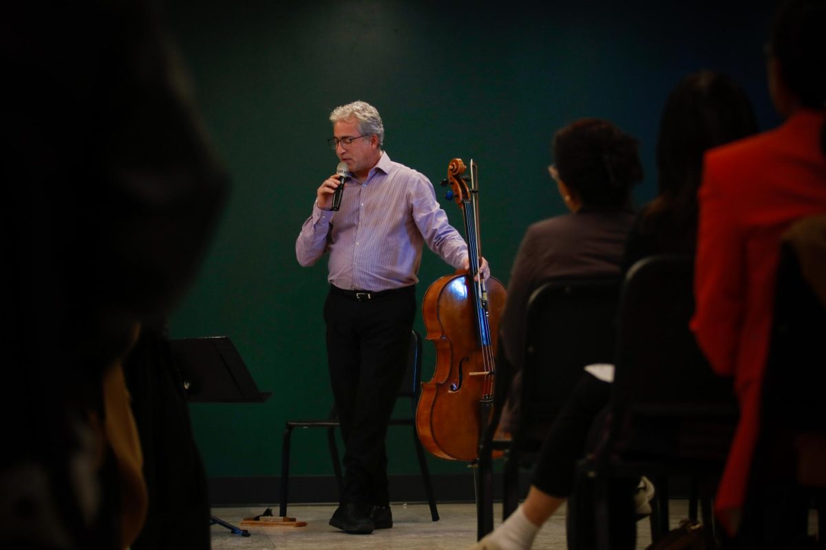 Guest artist Carey Bostian speaks on behalf of the Red Cedar Chamber Music Organization. Bostian and Miera Kim, the ensembles core members, performed duets to conclude the "Fall Fantasia" concert Nov. 15.