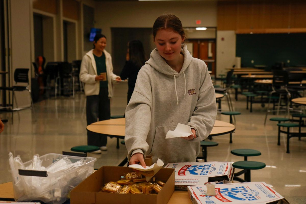 Audrey Crawford '26 takes food during the intermission of the "Fall Fantasia" concert in the West cafeteria. Over 20 businesses donated food and beverages for the concert Nov. 15.