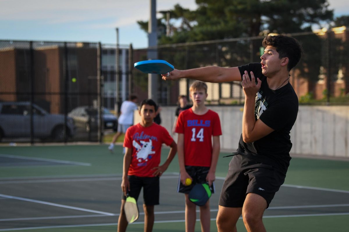 Anthony Medina, one of the pickleball tournament's winners, returns the ball during a heated match.