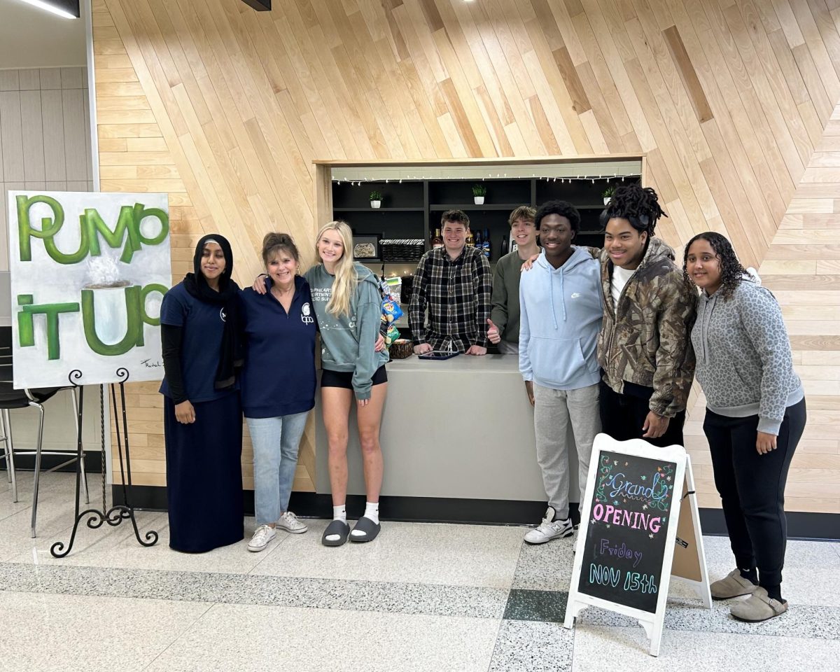 BPA advisor Diane Fickel and Pump it Up staff celebrate the grand opening of Pump it Up's new location.