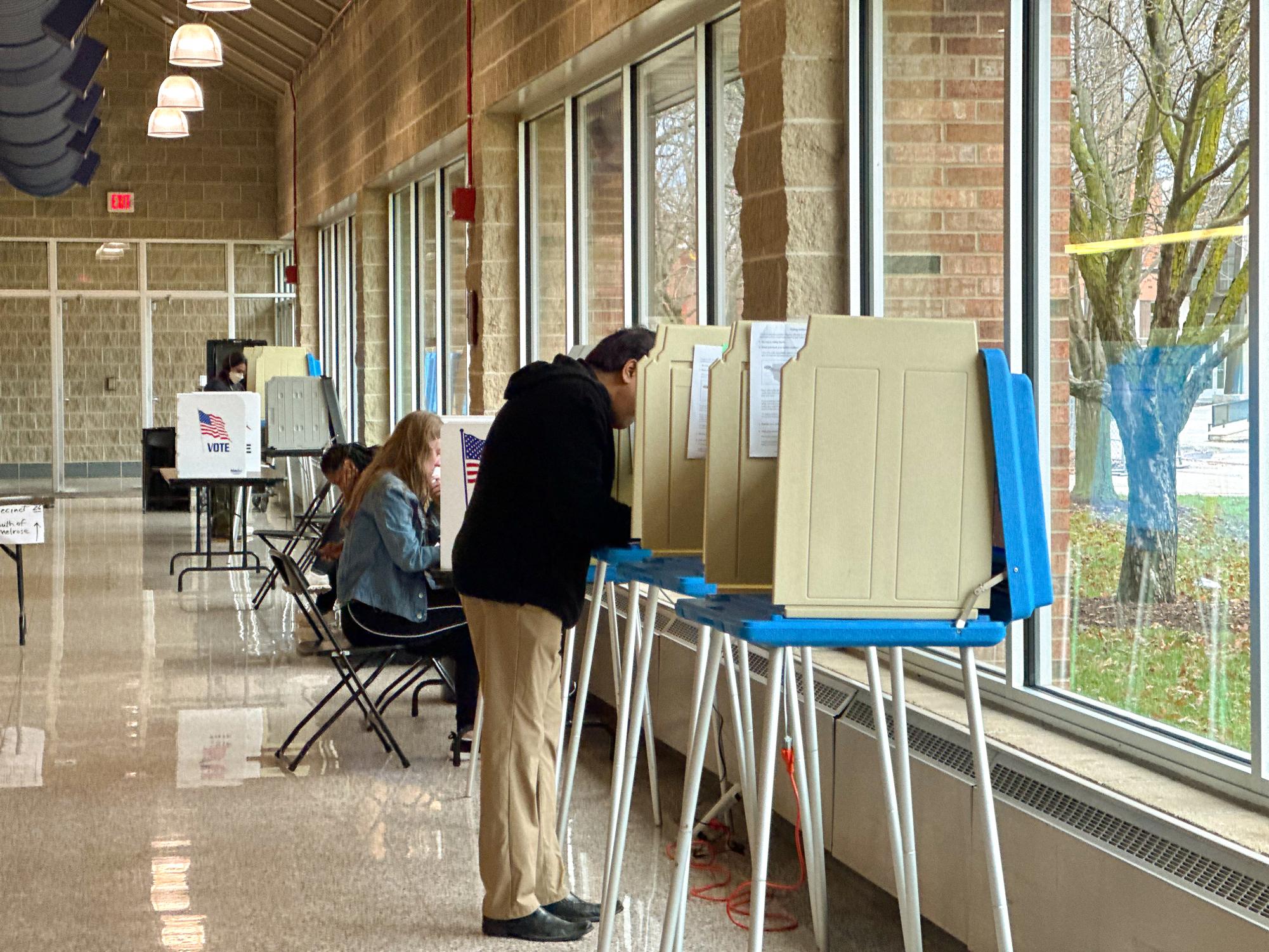 Voters line up to privately complete their ballots; once their ballot is filled, voters submit their slip into the ExpressVote machine. Photo taken with voter consent. 