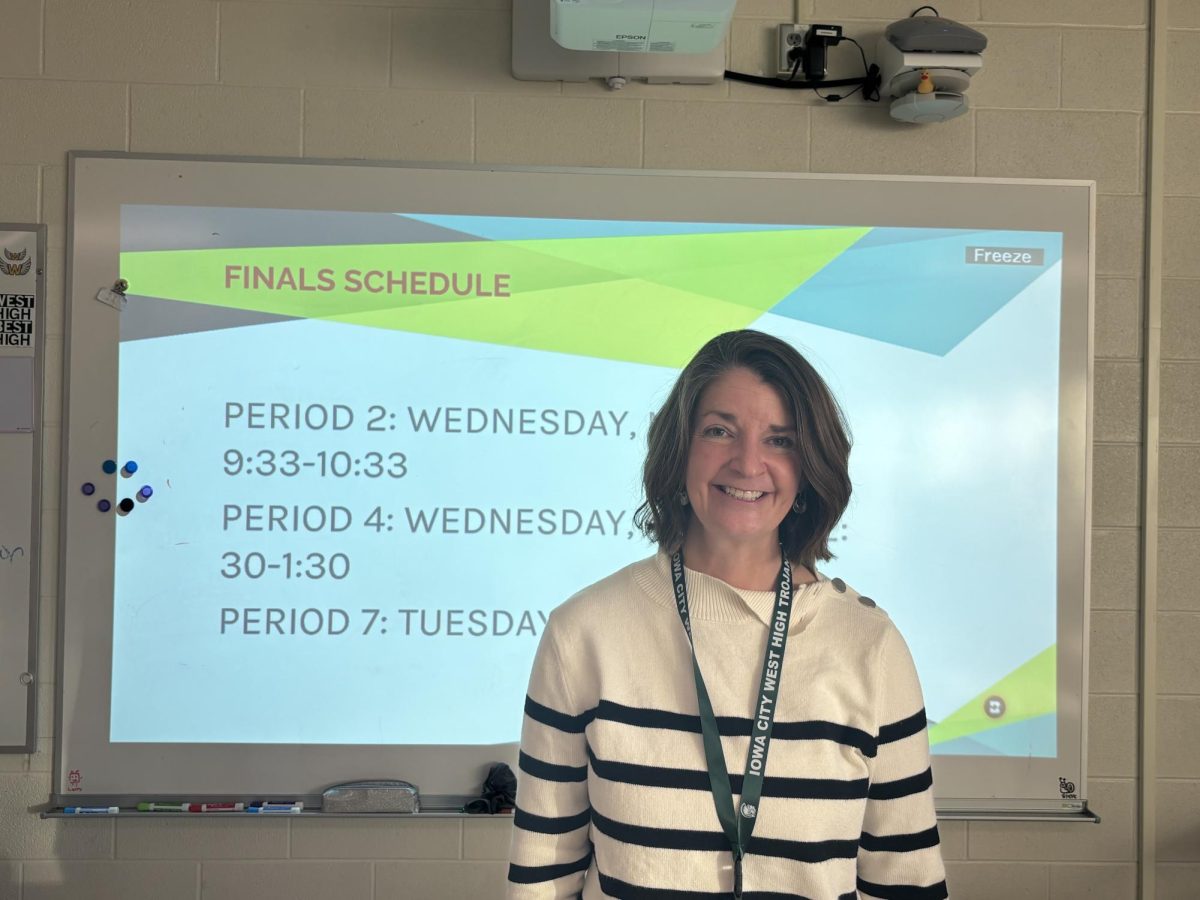 Beth Fettweis stands in front of the finals schedule for her English classes. 