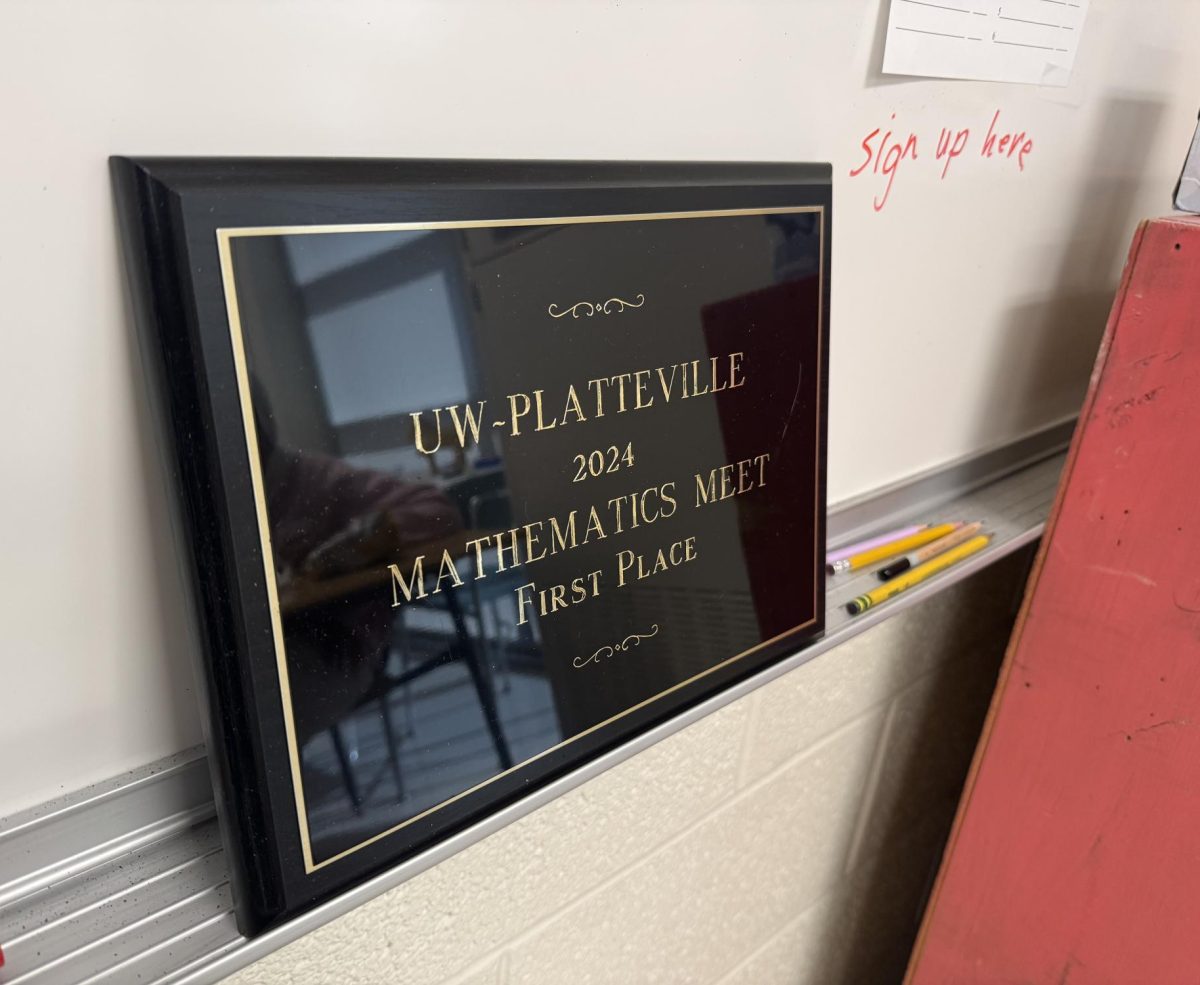 Club advisor, James Kirpes displays the team's first place award in the front of his math class room. 