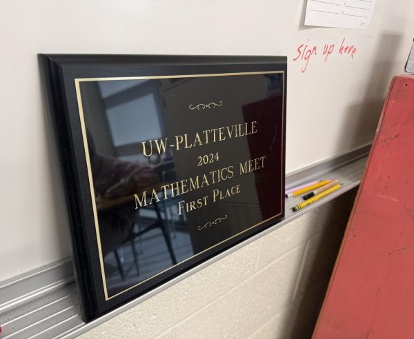 Club advisor James Kirpes displays the team's first place award in the front of his math class room. 