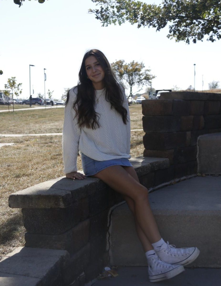 Caroline Dickens '27 poses for a picture wearing her denim skirt. 