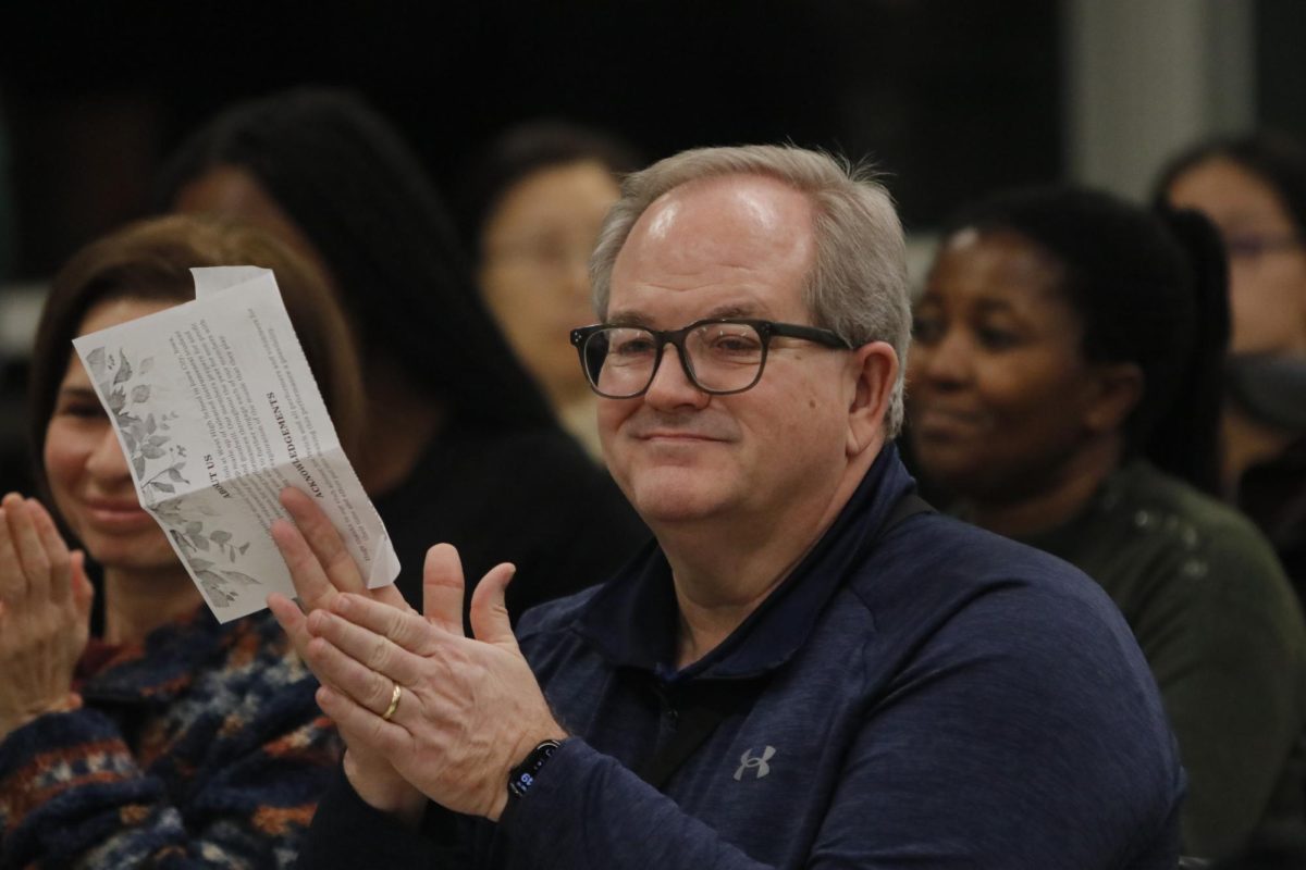 A member in the audience claps at the end of a performance at the "Fall Fantasia" concert Nov. 15.