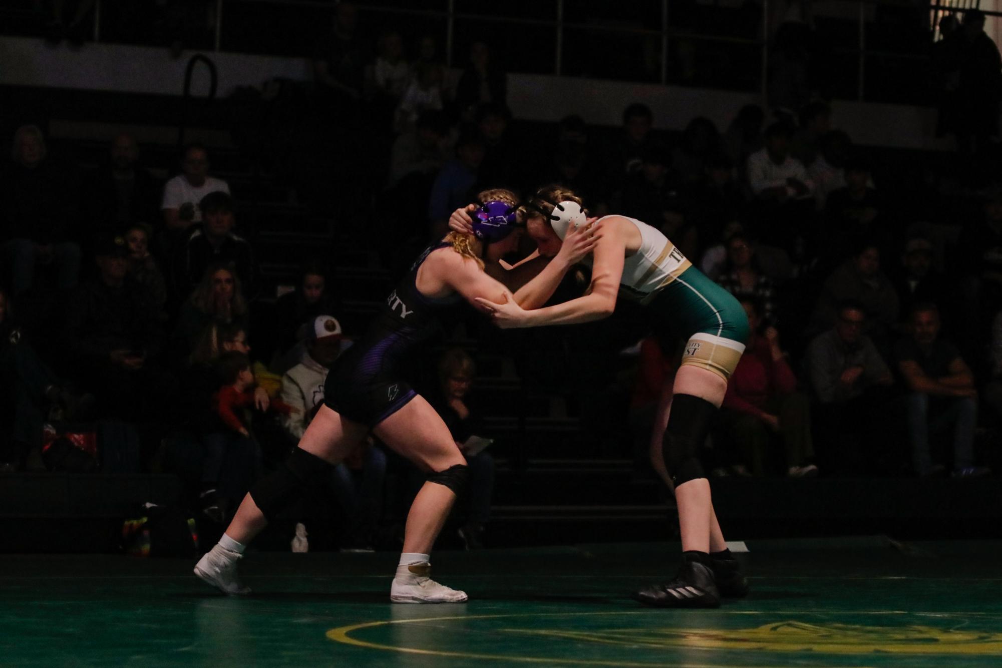 Harper Chase ‘25 goes head-to-head with her opponent at 140 pounds.