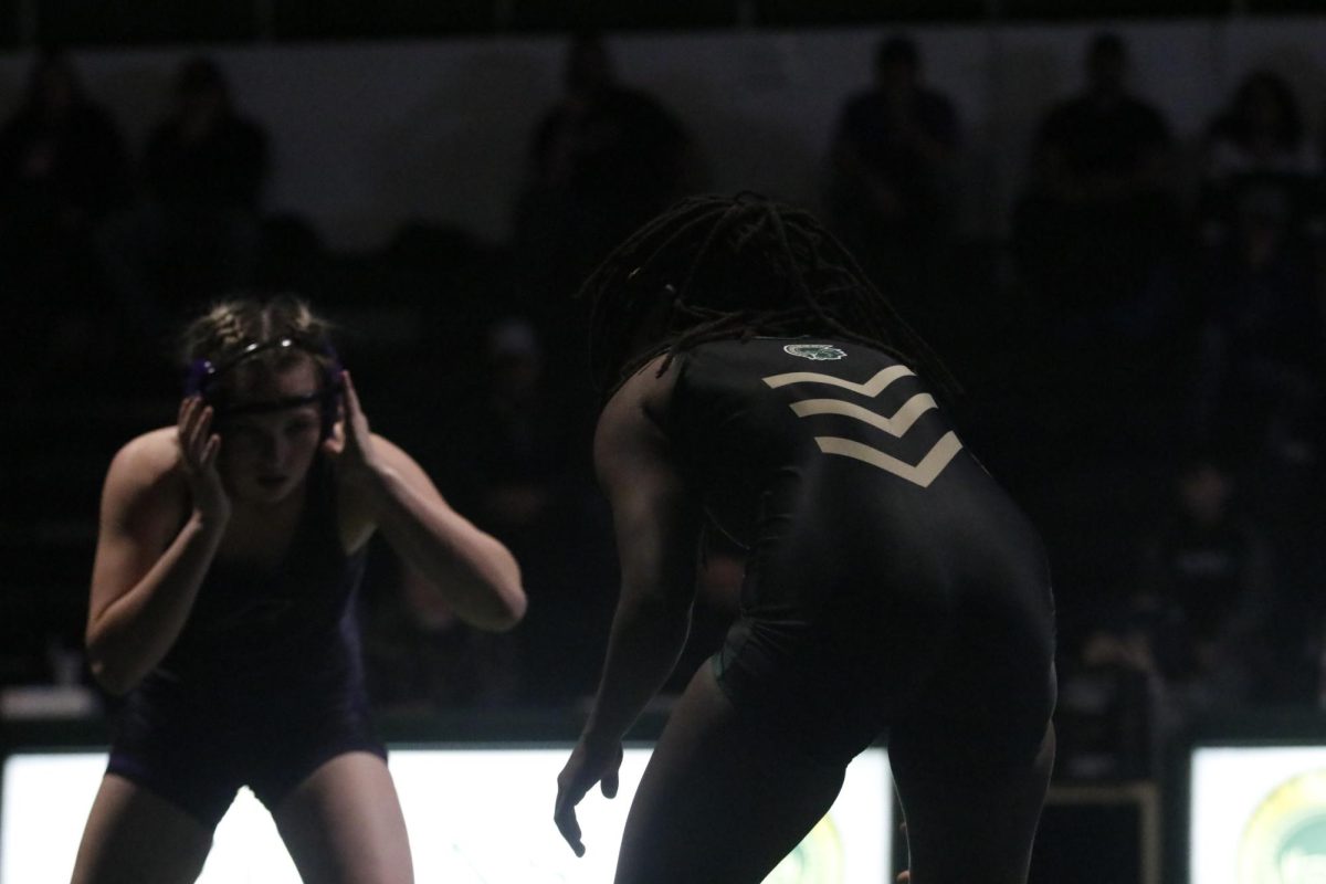 Trinity Meyers ‘25 stands in wait while her opponent fixes her headgear.