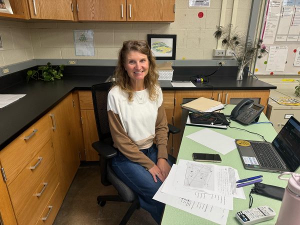 Andrea Harms sits at her desk in her classroom. 