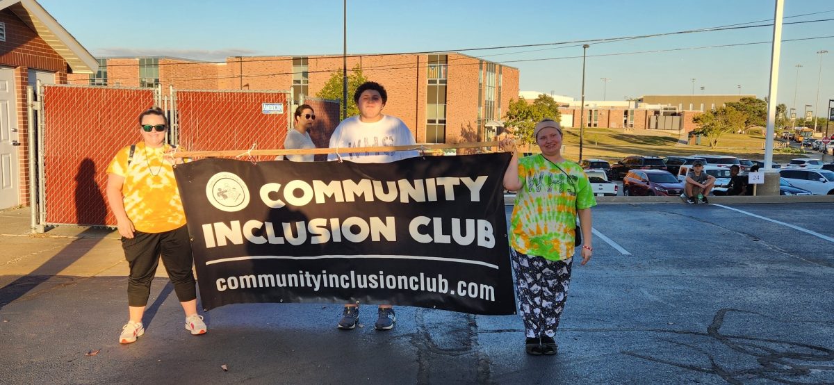 Community Inclusion Club members posing at the West High homecoming parade. 