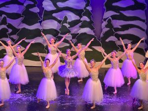 Grace Walker '26 and Sadie Frisvold '25 dance as the Snow Fairy and Snowflake, respectively, in Nolte Academy's 2023 performance of "The Nutcracker."