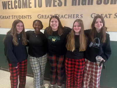 Lily's first spirit week at West High. She takes a photo with her friends in their pajama pants.
