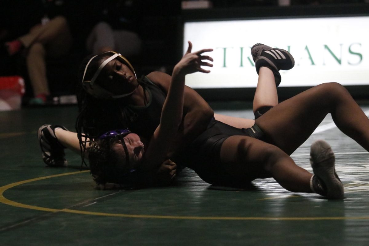 Trinity Myers '25 attempts to pin her opponent at the match against Liberty Nov. 21. 