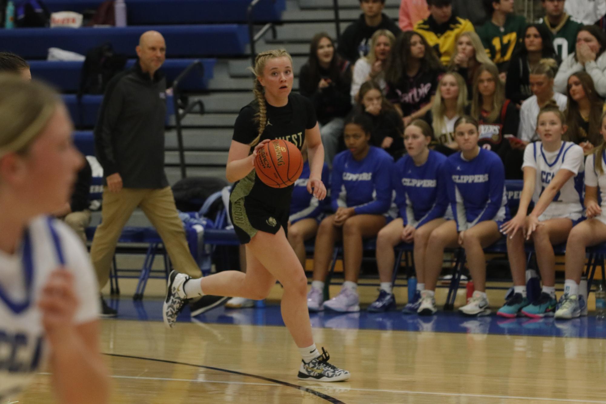 Grace Fincham '26 dribbles the basketball up the court during the game against Clear Creek Amana Dec. 3.