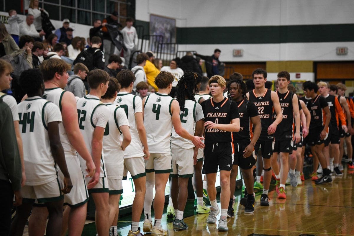 After the game, both teams line up to congratulate each other. The Trojans beat the Hawks 66-55.