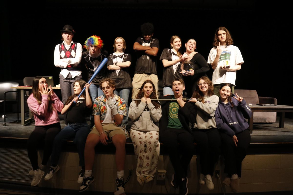 Grace Bartlett '25 (bottom right) poses with her Help Desk cast during dess rehersals.