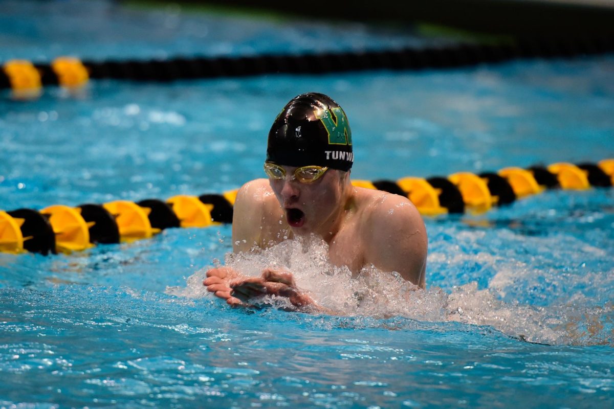 Liberty's Jack Tunwall '28 swims the 100-yard breaststroke preliminaries. 