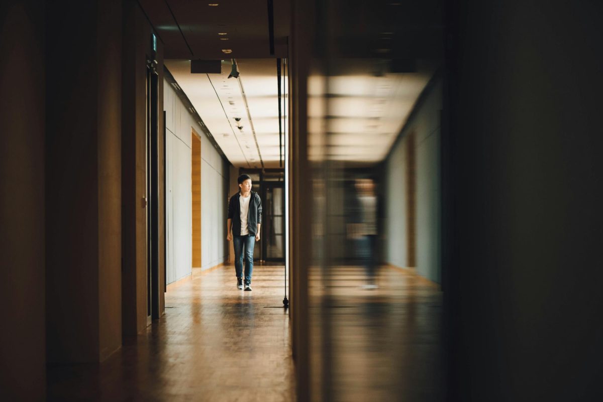 Student walking through school halls.