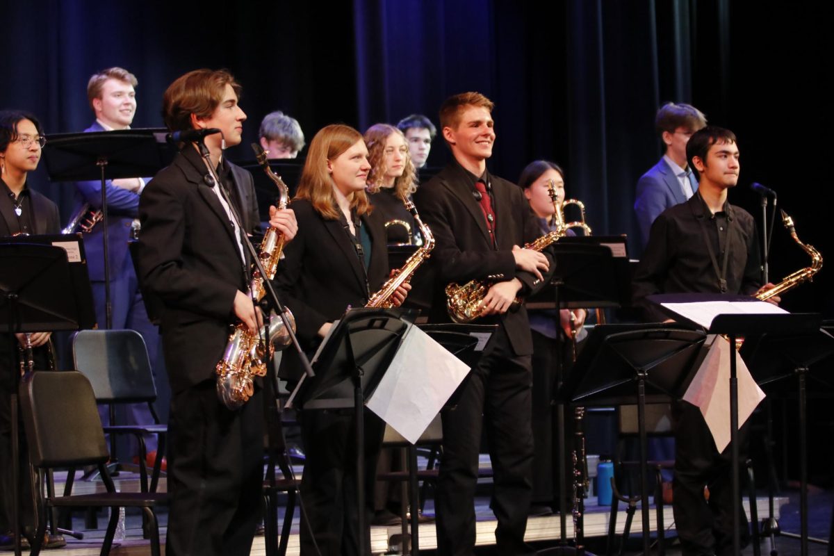 Saxophones Nathan Butler '27, Claire Lawler '25, Colin Wehrle '27 and Caleb Davies '26 stand for applause after finishing their performance.