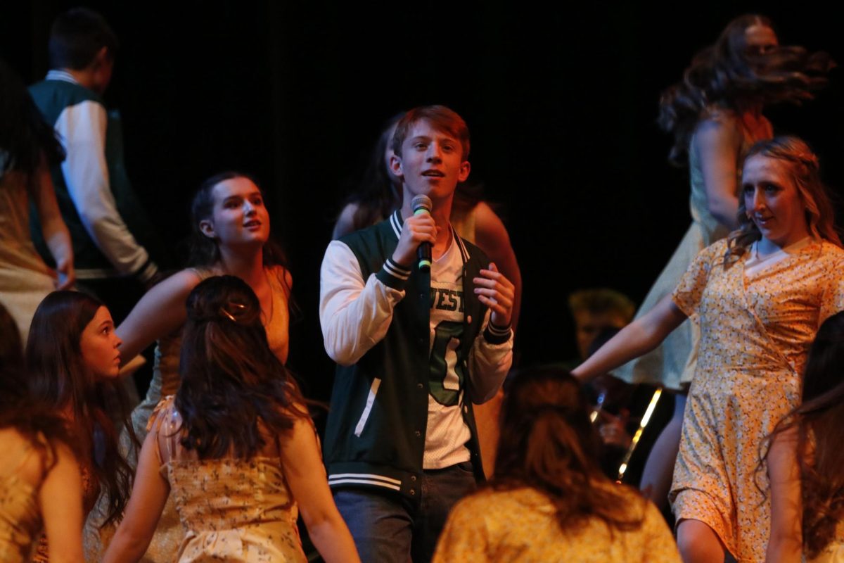 Eli Asper '25 sings his solo at Hancher Auditorium on Dec. 14, at West Side Story's annual Winter Swing Show. This year's theme was 'Homecoming'. 