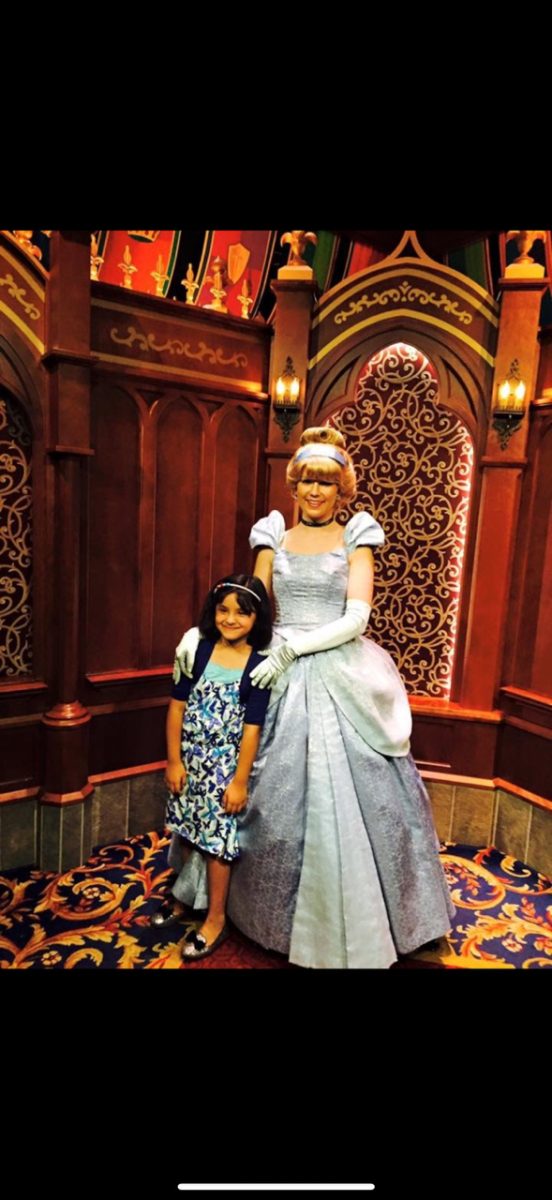 Kaleshna Udas '27, age 7, posing with "Cinderella" at Disney World