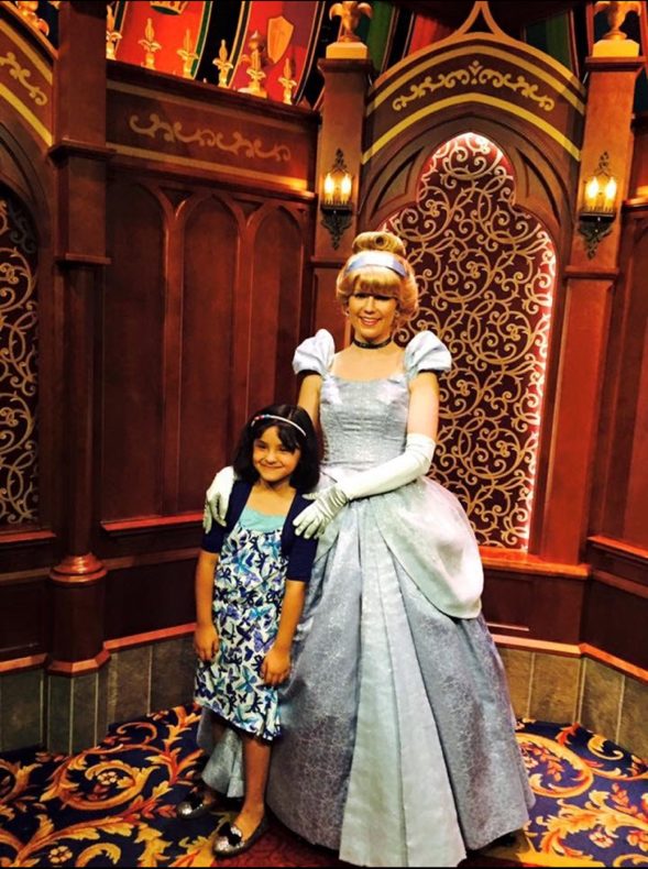 Kaleshna Udas '27, age 7, posing with "Cinderella" at Disney World