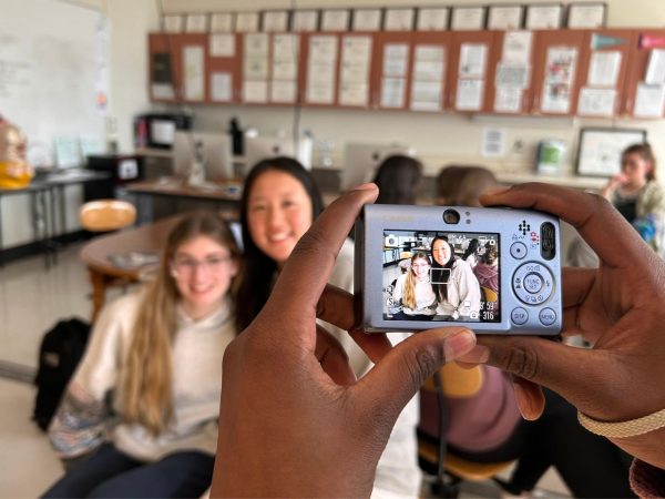 Lila Eastvold '27 and Gianna Liu '25 get their picture taken using a digital camera