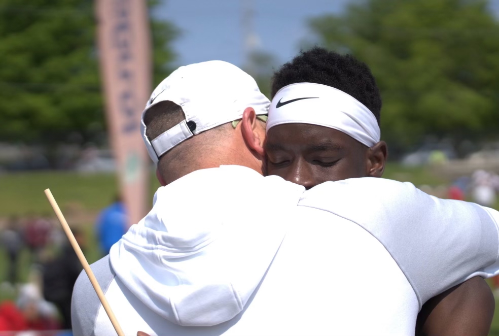 Coach Craig gives Moustafa Tiea '25 a hug at the Drake Relays meet after winning the distance medley relay and taking a victory lap.