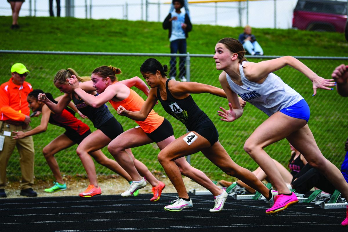 Just off the starting block, Sophia Olivo ‘25 runs in the preliminary 100-meter hurdles March 29.