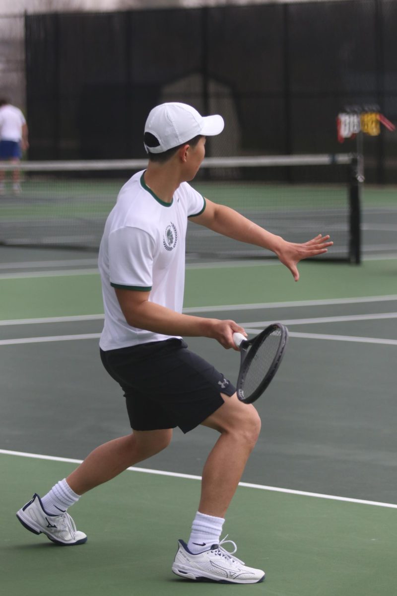 After the starting serve from a Wahlert player, Junze Sun '25 readies himself to return the serve.