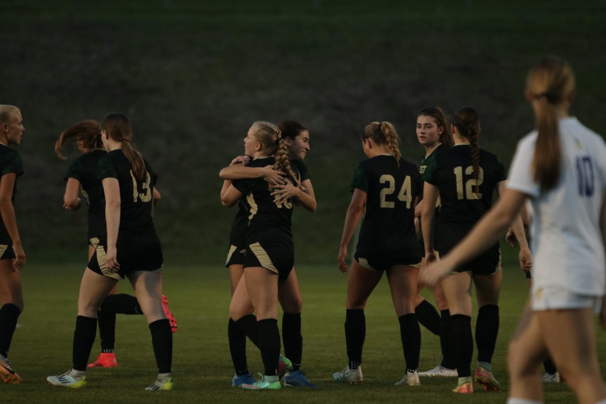 Amaia Martinez '27 hugs Sofia Fuentes '28 after a goal against Wahlert Catholic on April 22.
