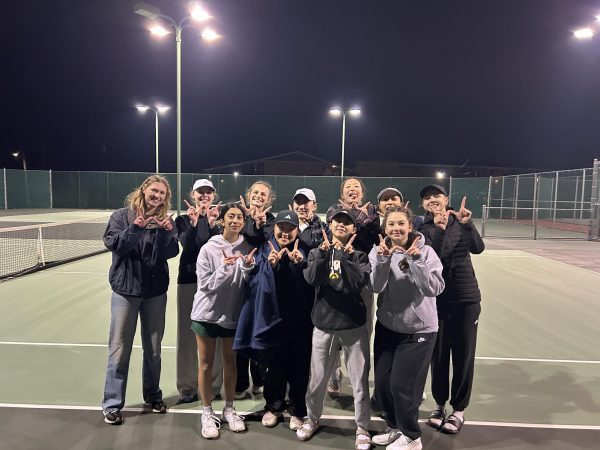 The West varsity girls tennis team celebrates their 8-1 win against Dubuque Wahlert after playing for almost four hours.

Photo Courtesy of Matt Stier