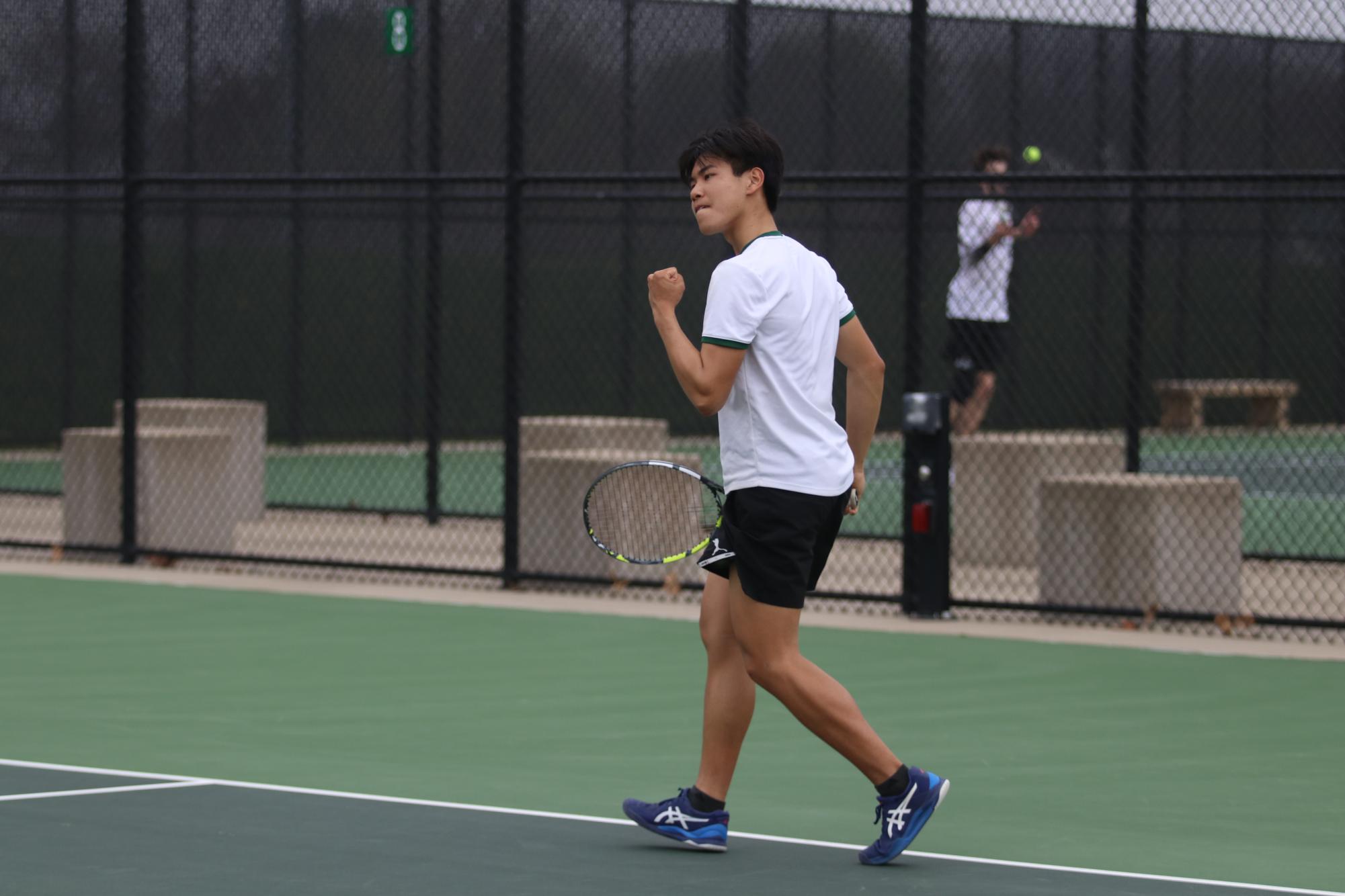 Derek Hua '25 celebrates a point against Dubuque Senior at the West High Courts April 18.