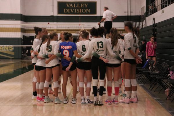 Iowa City West girls volleyball huddles up  before their game at the Live Like Line tournament.