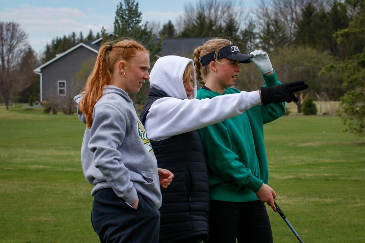 Coach Mary Goodfellow maps out the course to Lily Schmid '26 and Lily Collier '26