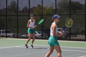 Seniors Sasha Postnikov and Marie Stier prepare to return a serve during the semi-final match. Postnikov and Stier won the match 6-0, 6-0. 