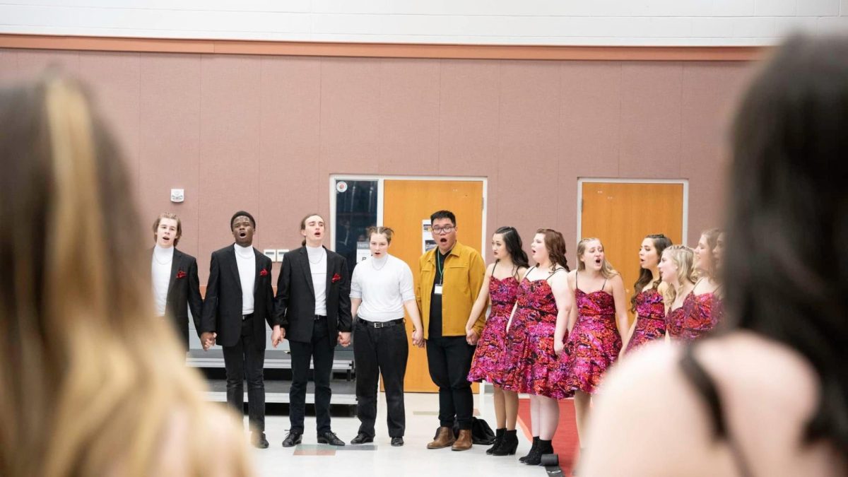 Luigi Enriquez signs with the Good Time Company show choir. Along with directing West choirs, Enriquez is also a trained opera singer and has performed at multiple local events.