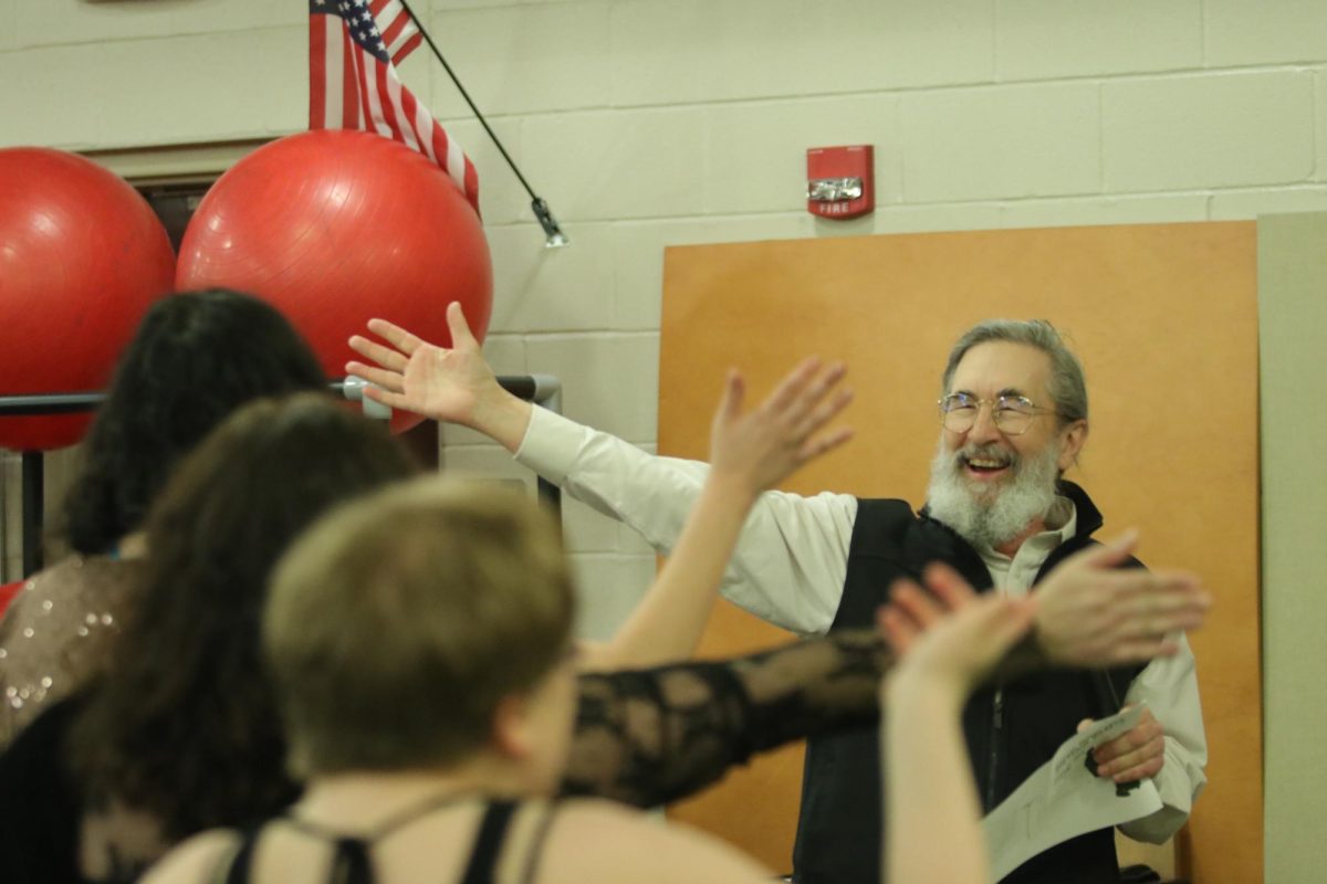 Steve Merkle gives out high fives at the Community Music Talent Show April 17.