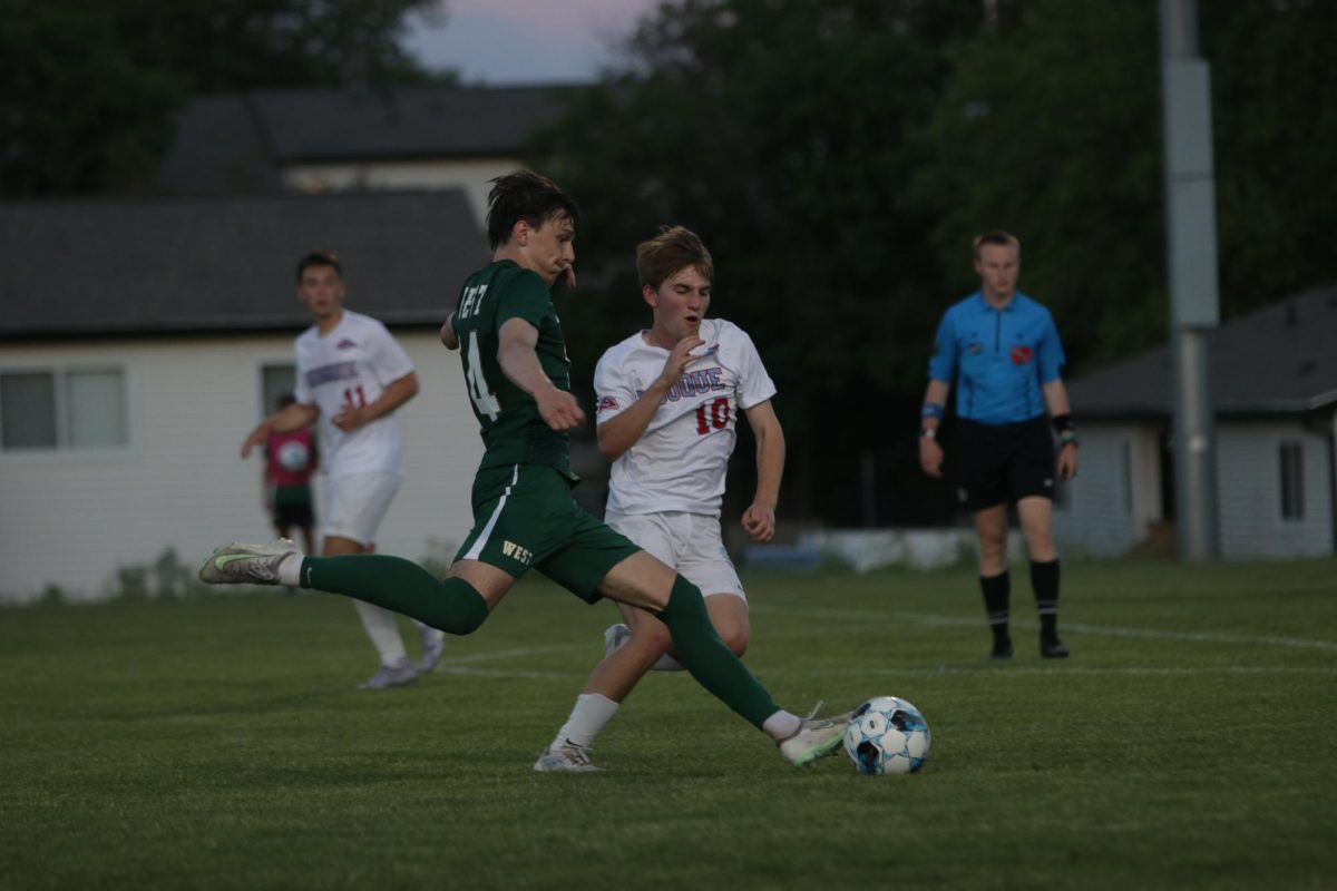 Caden Crabtree '25 lines up to kick the ball across the field.