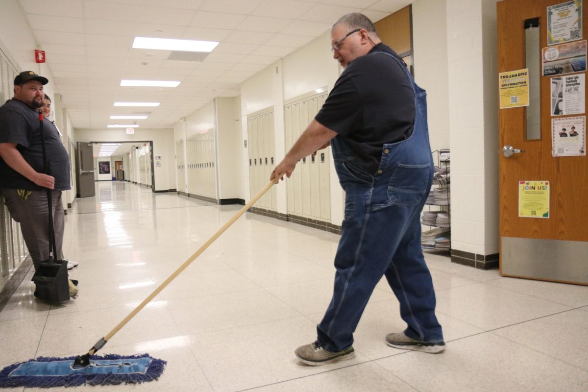 Donny Binegar mops the floor after school gets out.