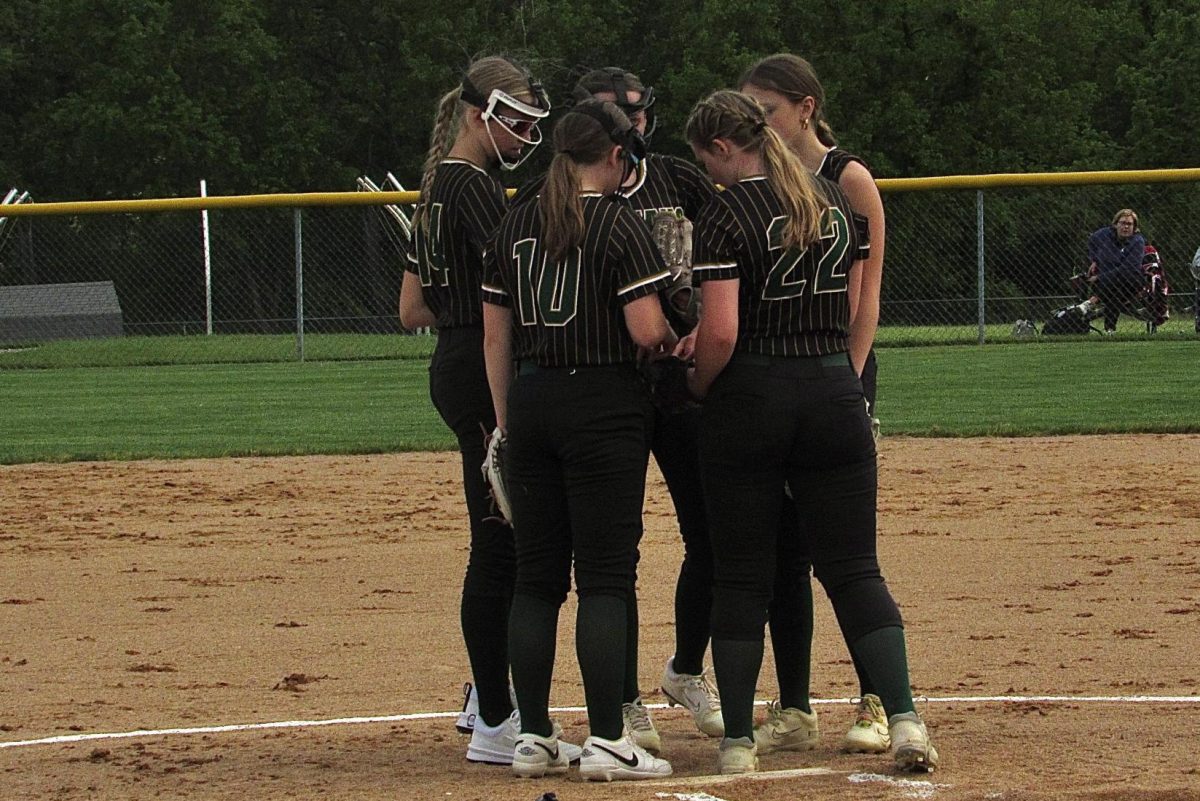 Players huddle on the pitcher's mound before the game starts. 