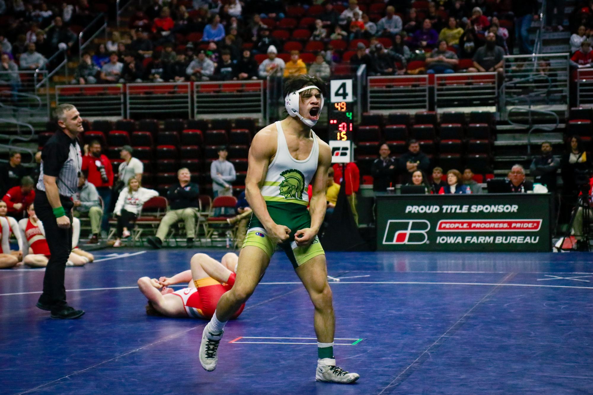 Justin Avila ’25 celebrates after beating his opponent in the 150lb finals at the state wrestling meet Feb. 22.