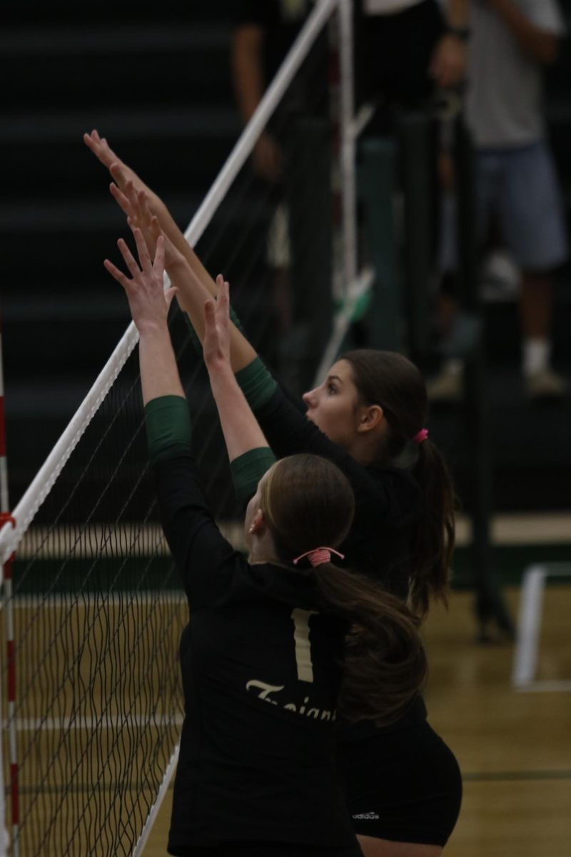 Cyan Blommer '29 and Audrey Small '28(?) block the Bobcats' right side hitter.