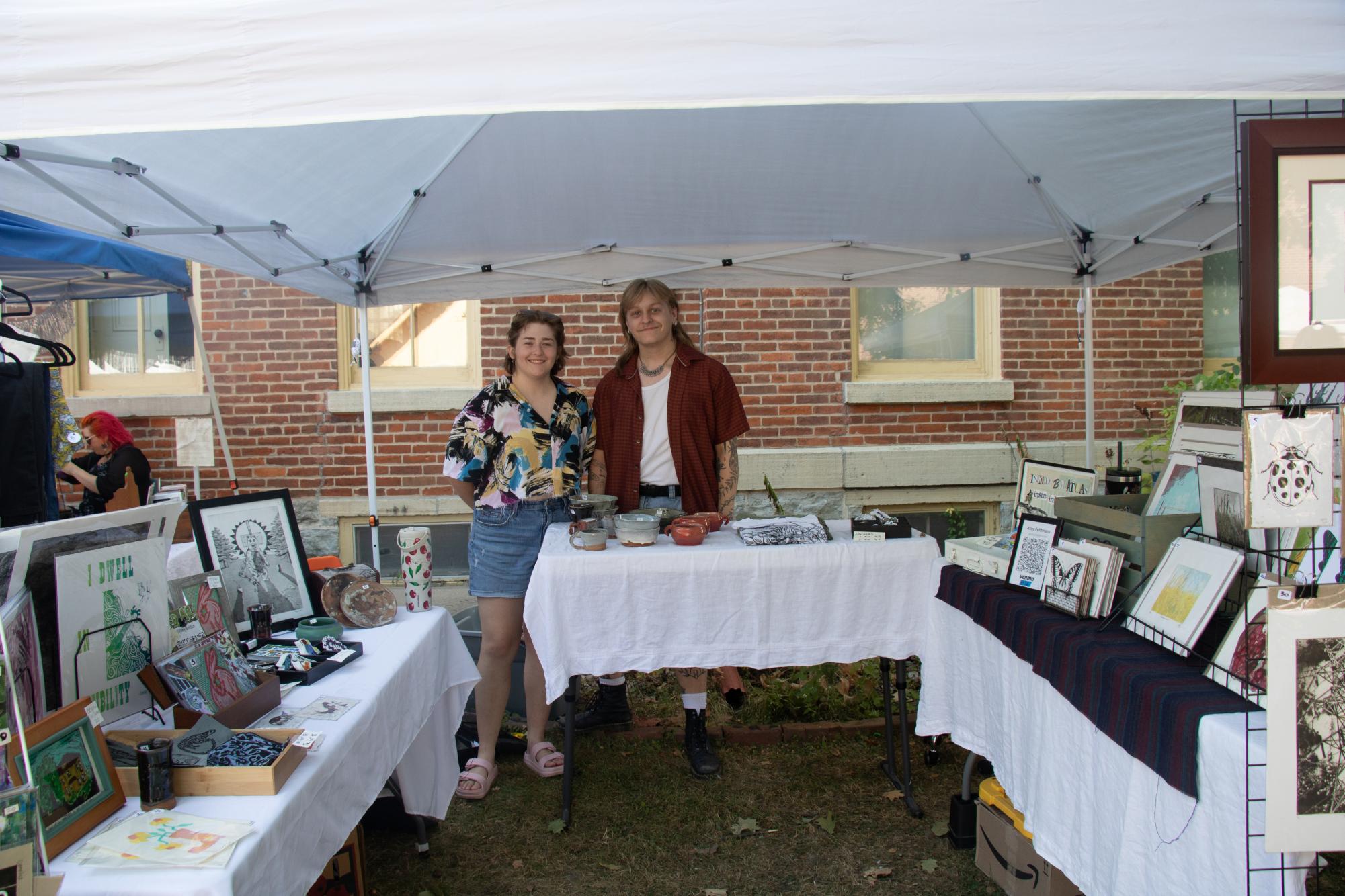Riley and Atlas share their booth at the flea market, featuring their handmade prints. 