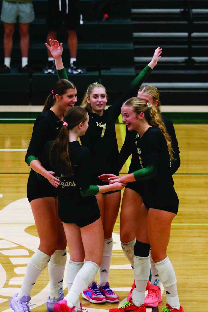 The West High volleyball team huddles after a point Sep. 23.